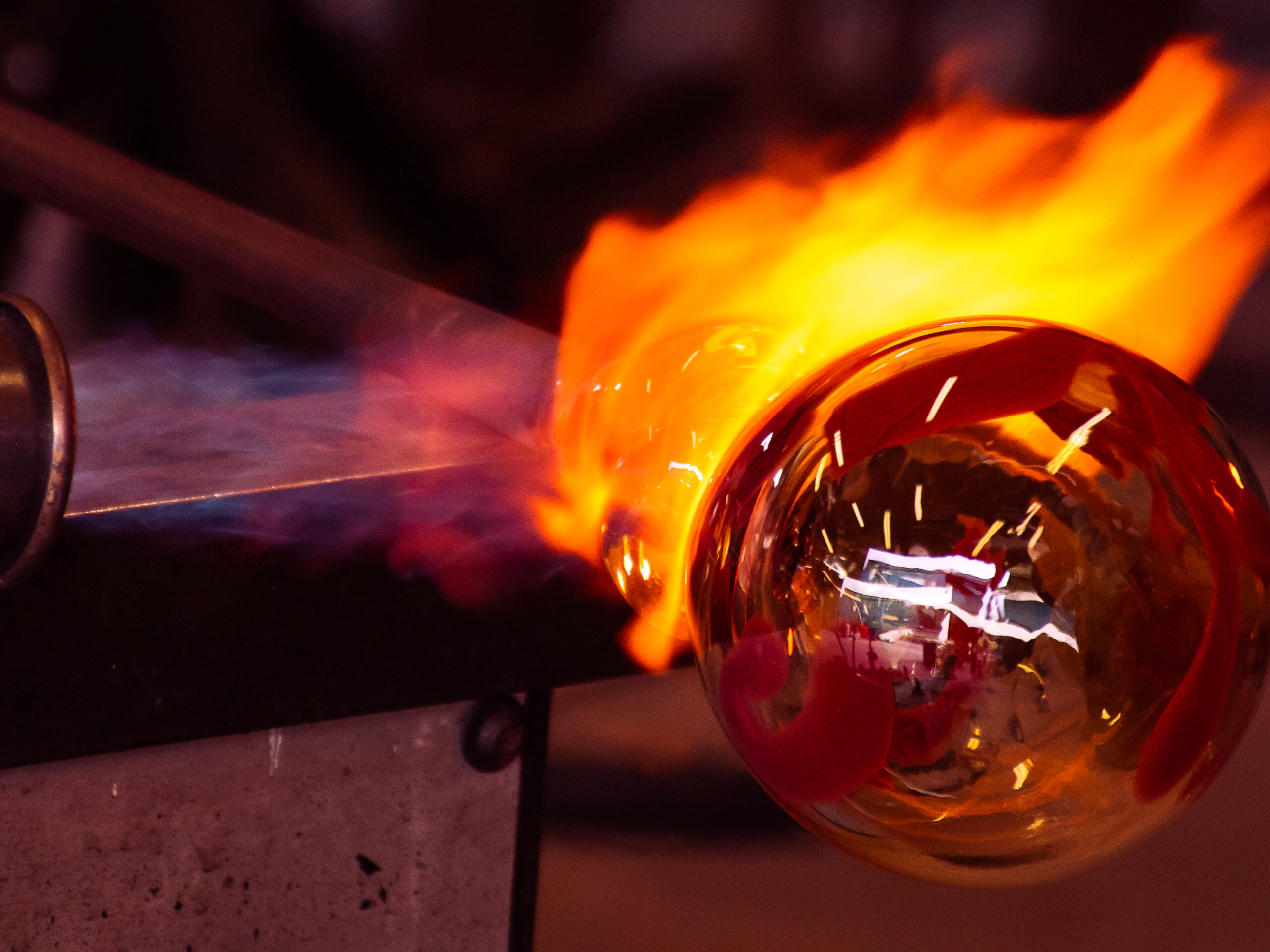 torching the neck of a blown glass piece